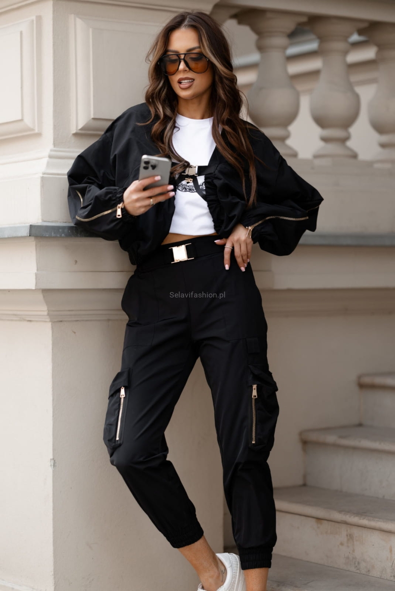 Spodnie bojówki z naszytymi kieszeniami typu kargo firmy Lavestino. Stylowe i praktyczne bojówki damskie z klamrą w pasie. Wykonane z wytrzymałego materiału, idealne na co dzień. Posiadają pojemne kieszenie i luźniejszy krój zapewniający wygodę ruchu.