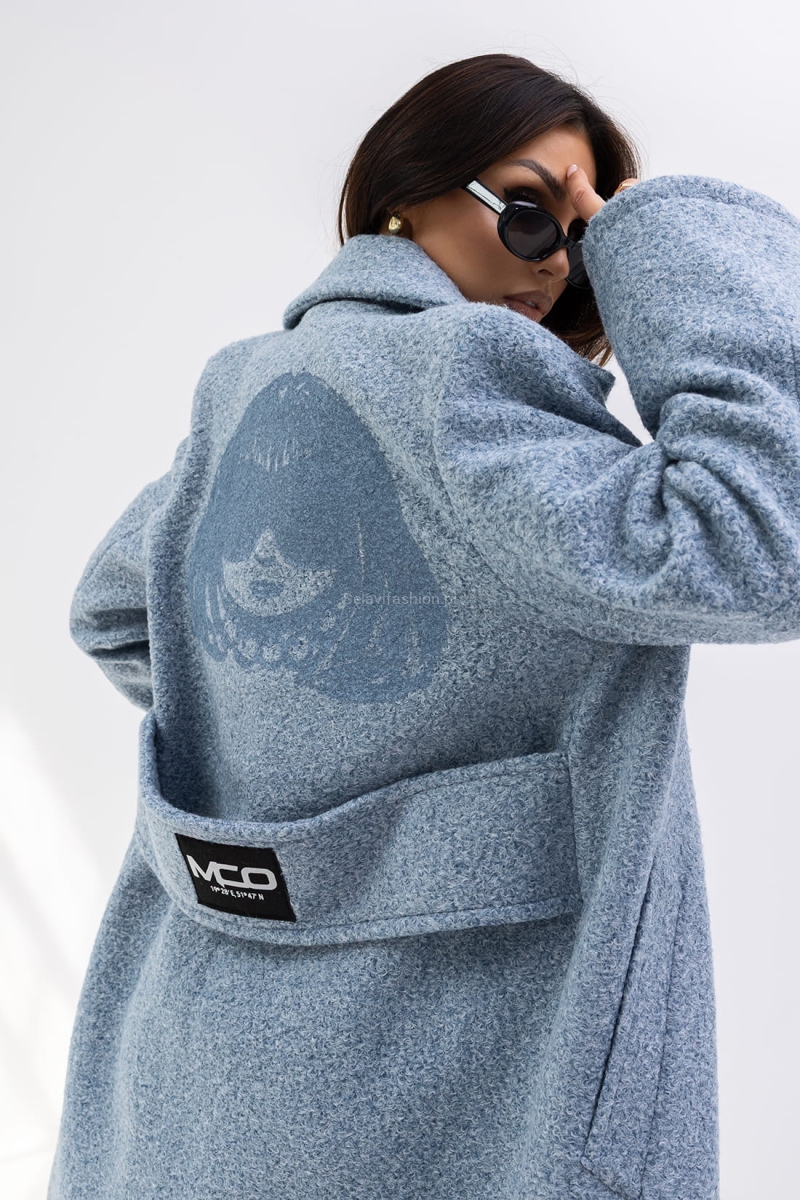 Długi płaszcz The City producenta Miss City Official uszyty jest z grubej gramaturze. Płaszcz posiada dłuższe rękawy, lekko rozkloszowane. Z tyłu na plecach ozdobny pasek z logo oraz aplikacja, która dodaje mu wyjątkowego charakteru